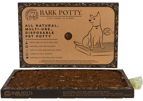 A Bark Potty all-natural disposable dog pad displayed with its packaging as an indoor dog pee station.